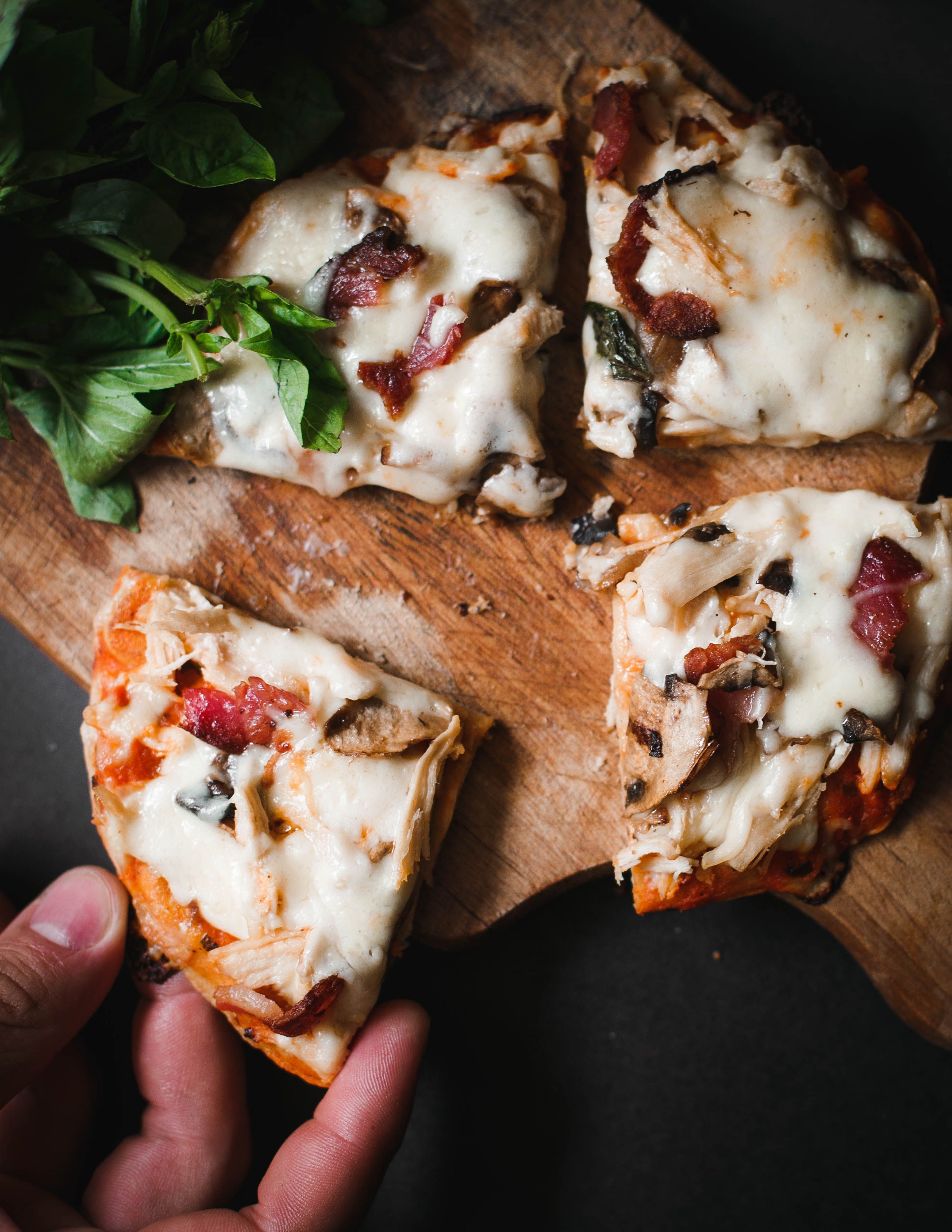 Pizza slices on a wooden board.