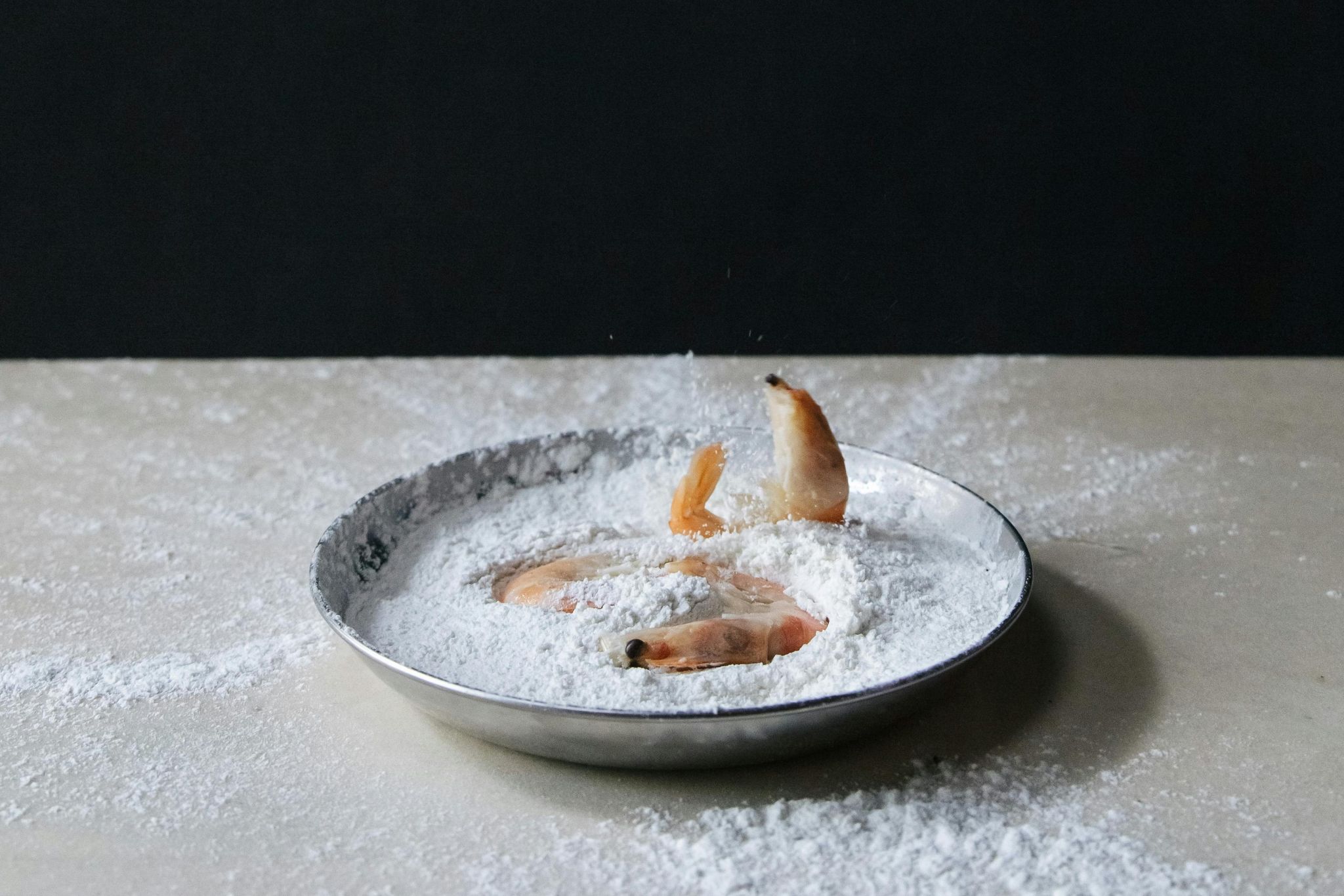 Fish pieces resting in flour.