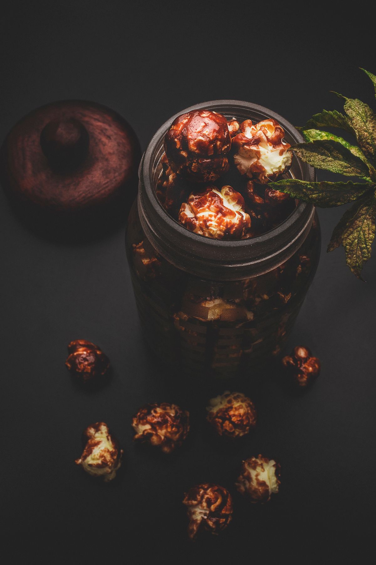 Caramel-coated popcorn in a glass jar.