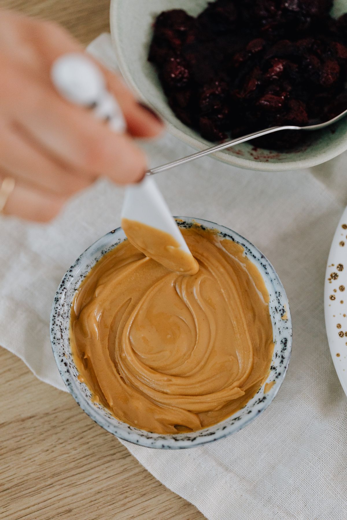 Peanut butter in a bowl with a spatula.