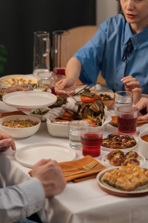 People serving food at a table.