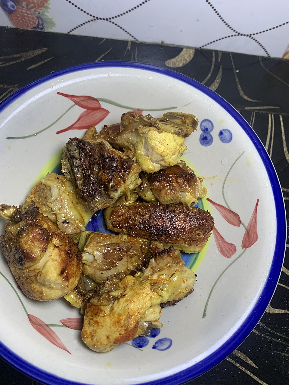 Illustrative browned chicken on a floral plate; not Chipotle Honey Chicken.