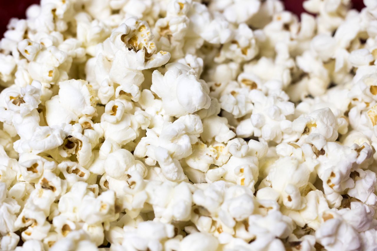 White popped corn kernels fill the frame.