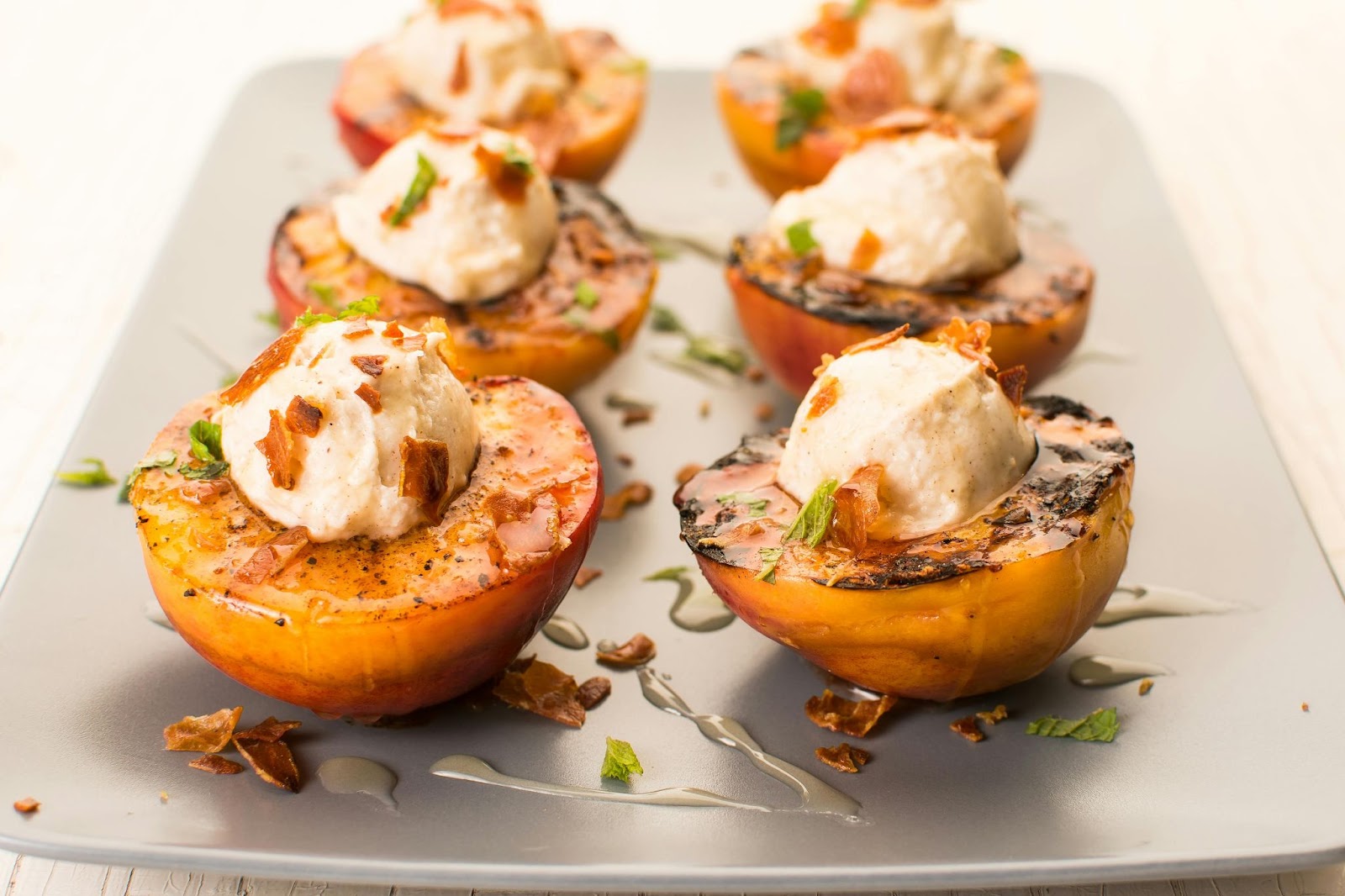 Grilled peach halves topped with ice cream.